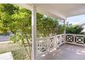 White wooden front porch railing and view of landscaping at 21787 Unbridled Ave, Parker, CO 80138