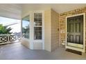 Covered front porch with a bay window and dark-colored front door at 21787 Unbridled Ave, Parker, CO 80138