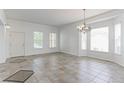 Bright living room boasting tiled floors and ample natural light from large windows at 2631 E 136Th Pl, Thornton, CO 80602