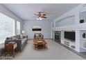 Bright living room with a ceiling fan, fireplace, and large windows that allow plenty of natural light to enter at 2631 E 136Th Pl, Thornton, CO 80602