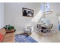 Elegant dining room with high ceilings, modern chandelier, and stylish decor at 9854 Merimbula St, Highlands Ranch, CO 80130