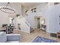 Spacious foyer with a grand staircase, leading to the upper level of the home at 9854 Merimbula St, Highlands Ranch, CO 80130