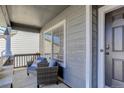 Inviting front porch with comfortable seating, perfect for relaxing and enjoying the neighborhood views at 9854 Merimbula St, Highlands Ranch, CO 80130