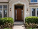 Inviting front door with decorative sidelights and stylish wall-mounted lanterns at 5700 S Benton Cir, Littleton, CO 80123
