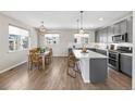 Bright kitchen with stainless steel appliances, gray cabinets and a large island with bar seating at 4265 E Iliff Ave # 1, Denver, CO 80222