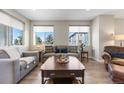 Cozy living room featuring plush sofas, large windows, and a rustic coffee table at 4265 E Iliff Ave # 1, Denver, CO 80222