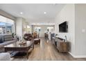 Open-concept living room with wood floors, a comfortable seating area, and an adjacent dining area at 4265 E Iliff Ave # 1, Denver, CO 80222