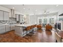 Open kitchen with a large island, modern gray cabinets, and stainless steel appliances at 5799 Boston St, Denver, CO 80238