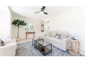 Comfortable living room with sofa, chair, leafy plant, and a bright window at 1361 W Custer Pl, Denver, CO 80223