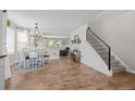 Cozy dining area with a modern chandelier, wood floors, and easy access to the staircase at 5010 Ox Trl, Parker, CO 80134