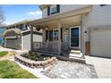 Inviting front porch with a welcome sign, lovely landscaping, and charming decorative details at 5010 Ox Trl, Parker, CO 80134