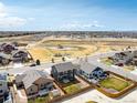 Aerial view showcases neighborhood with community park, nearby houses, and open spaces at 6707 6Th St, Frederick, CO 80530