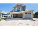 Charming two-story home featuring stone accents, a covered porch, open garage space, and a well-maintained lawn at 6833 E 115Th Ave, Thornton, CO 80233