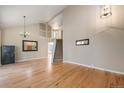 Bright living room with hardwood floors, staircase, and large windows at 6833 E 115Th Ave, Thornton, CO 80233