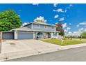 Beautiful two-story home with attached garage and well-maintained lawn at 10925 W Montana Pl, Lakewood, CO 80232