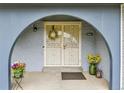 Close up of the charming, decorated front door with secure screen at 10925 W Montana Pl, Lakewood, CO 80232