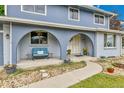 Inviting front porch with cozy seating and decorative landscaping at 10925 W Montana Pl, Lakewood, CO 80232