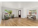 Light-filled living room features new flooring, neutral paint, and an ornate front door at 2965 Ivy St, Denver, CO 80207