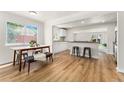 Bright open floorplan features seamlessly connected kitchen and dining areas at 2965 Ivy St, Denver, CO 80207