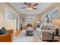 Bright living room with hardwood floors, large windows, neutral walls, and stylish furniture at 2248 Lima St, Aurora, CO 80010