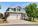 Charming two-story home with a three car garage and craftsman details at 9745 Hummingbird Pl, Littleton, CO 80125