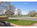 Landscaped front yard features a fire pit, bench, and views of the open green space across the street at 11416 E 114Th Ave, Commerce City, CO 80640