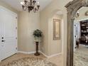 Elegant foyer with tiled flooring, decorative chandelier, and arched doorway to another room at 9546 Firenze Way, Highlands Ranch, CO 80126