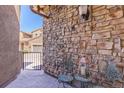 Cozy outdoor patio featuring brick accent wall and seating area, perfect for relaxation at 9546 Firenze Way, Highlands Ranch, CO 80126