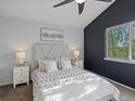 Serene bedroom with a large window, a statement wall, and well-coordinated furnishings at 5115 S Valdai St, Aurora, CO 80015