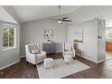 Cozy living room featuring vaulted ceilings, hardwood floors, a ceiling fan, and neutral decor at 5115 S Valdai St, Aurora, CO 80015