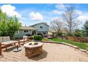 Outdoor patio with a stone fire pit, furniture, and a well-maintained lawn at 705 Prairie Ridge Rd, Highlands Ranch, CO 80126