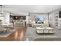 Open-concept living room and kitchen area with hardwood floors and bar seating at 540 E Fremont Pl, Centennial, CO 80122