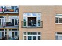 Close-up of balcony with railing and plants outside window and a peek inside at 7240 W Custer Ave # 303, Lakewood, CO 80226