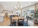 Open-concept dining area leads to the kitchen, living room, and backyard at 14423 Shasta Daisy Ln, Parker, CO 80134