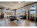 Living room area filled with natural light, hardwood flooring, and views of the cityscape at 1925 W 32Nd Ave # 404, Denver, CO 80211