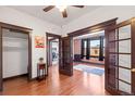 Inviting living room with hardwood floors, dark trim, pocket doors leading to the brick accent wall, and a closet at 1475 N Humboldt St # 20, Denver, CO 80218