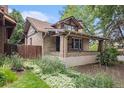 Charming brick home with a covered front porch and mature landscaping at 4010 Grove St, Denver, CO 80211