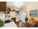 Efficient kitchen with white countertops, ample storage, and updated appliances at 4010 Grove St, Denver, CO 80211