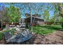 Lush backyard with a well-maintained lawn and a quaint outdoor seating area at 1027 S University Blvd, Denver, CO 80209