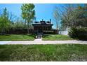 Charming home with a well-manicured lawn and inviting curb appeal at 1027 S University Blvd, Denver, CO 80209
