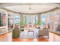 Bright living room with a wall of windows, hardwood floors, and cozy seating perfect for relaxation at 3249 W Fairview Pl # 106, Denver, CO 80211