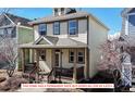 Charming two-story home featuring a welcoming front porch with sturdy columns and a well-maintained yard at 4523 Crestone Peak St, Brighton, CO 80601