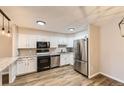 Modern kitchen with stainless steel appliances, granite countertops, and white cabinets at 3082 S Wheeling Way # 203, Aurora, CO 80014