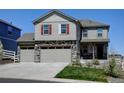 Charming two-story home with stone accents, a three-car garage and well-maintained landscaping at 5837 High Timber Cir, Castle Rock, CO 80104