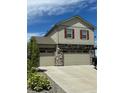 Two-story home featuring a three-car garage, stone accents, and red window shutters at 5837 High Timber Cir, Castle Rock, CO 80104