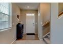Bright foyer with wood floors, staircase, and a conveniently placed shoe rack at 5837 High Timber Cir, Castle Rock, CO 80104