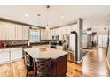 Spacious kitchen featuring a large island, stainless steel appliances, and hardwood floors at 240 Corby Pl, Castle Pines, CO 80108