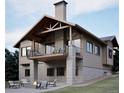 Attractive home showcasing a walkout basement, patio with fire pit, and an inviting covered balcony above at 680 Lone Eagle Dr, Granby, CO 80015
