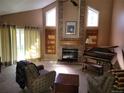 Inviting living room with vaulted ceilings, large windows, fireplace, piano, and comfortable seating for relaxation at 2619 S Iris Ct, Lakewood, CO 80227