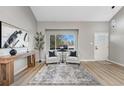 Bright living room featuring a large window and modern decor at 12018 Hudson Ct, Thornton, CO 80241